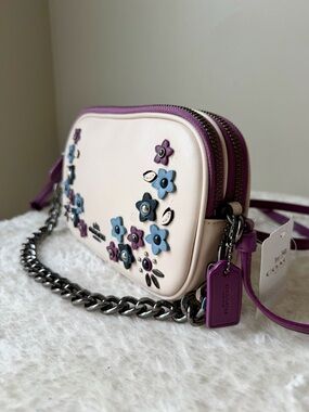 NWT Coach bag crossbody with lavender floral appliqué and chain charm